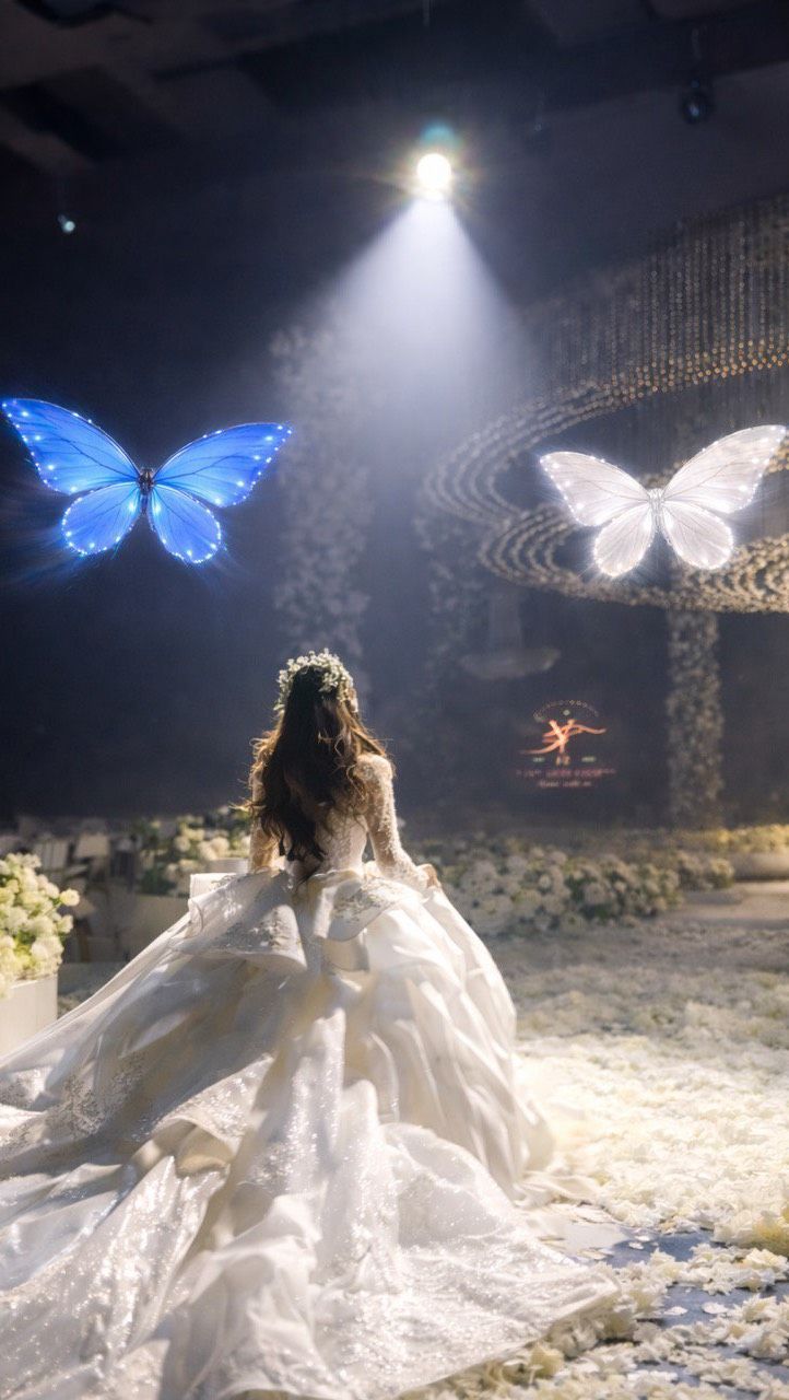 Glowing LED butterfly drones flying above a bride
